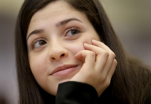 Syrian swimmer Yusra Mardini who fled to Germany with her family and who is currently training with a local swimming club attends a joint press conference of the International Olympic Committee (IOC) and the German Olympic Sports Confederation (DOSB) in Berlin, Germany, Friday, March 18, 2016. The IOC is supporting refugee athletes who could potentially qualify for the Olympic Games Rio de Janeiro 2016. One of them is 17 year old Syrian swimmer Yusra Mardini. (AP Photo/Michael Sohn)